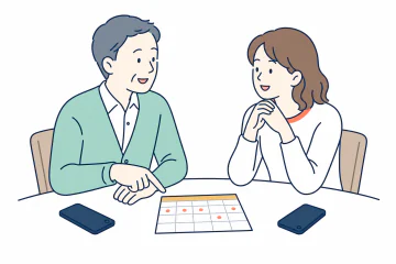 スマートフォンを置き、共有記録を見る頻度についてカレンダーを見ながら話す二人